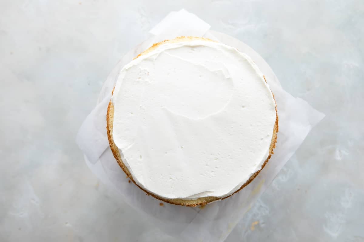 Frosting the top of a Danish layer cake with vanilla buttercream.