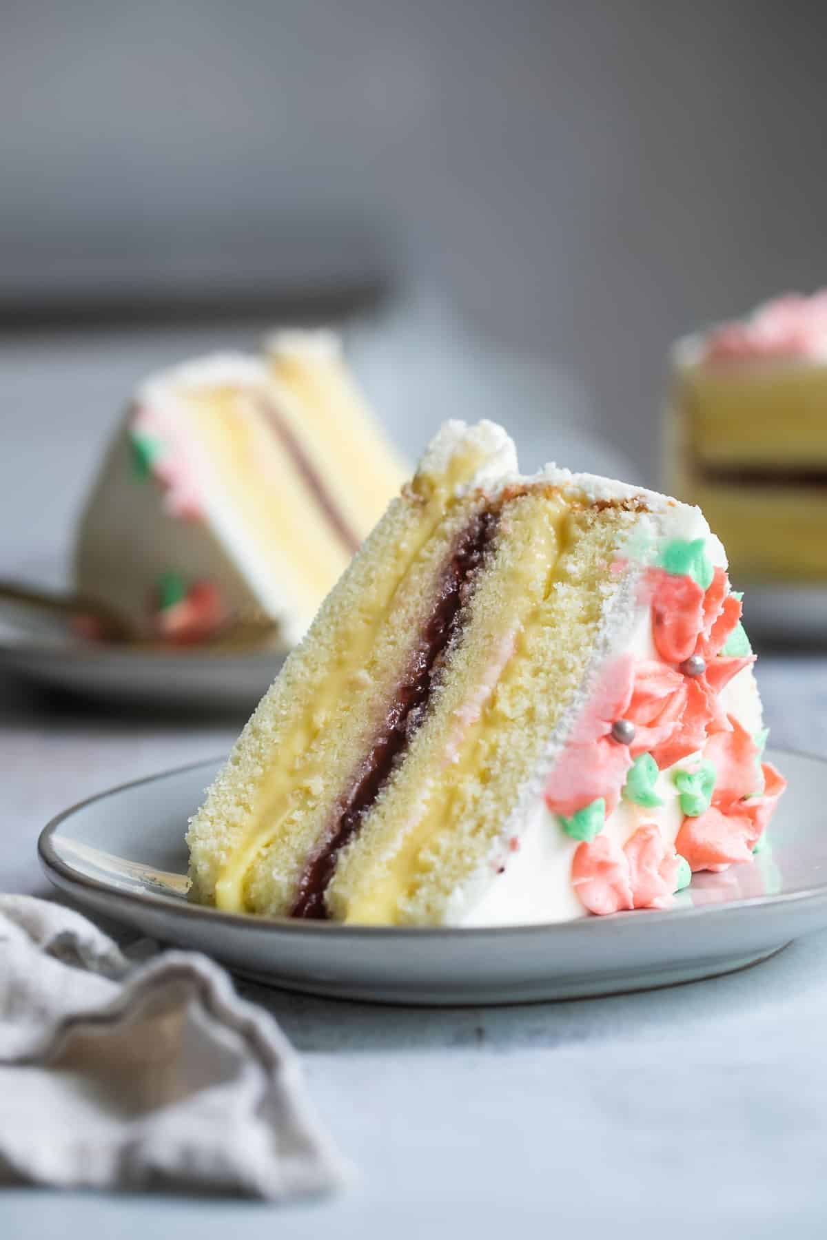 Slices of Danish layer cake on plates with forks.