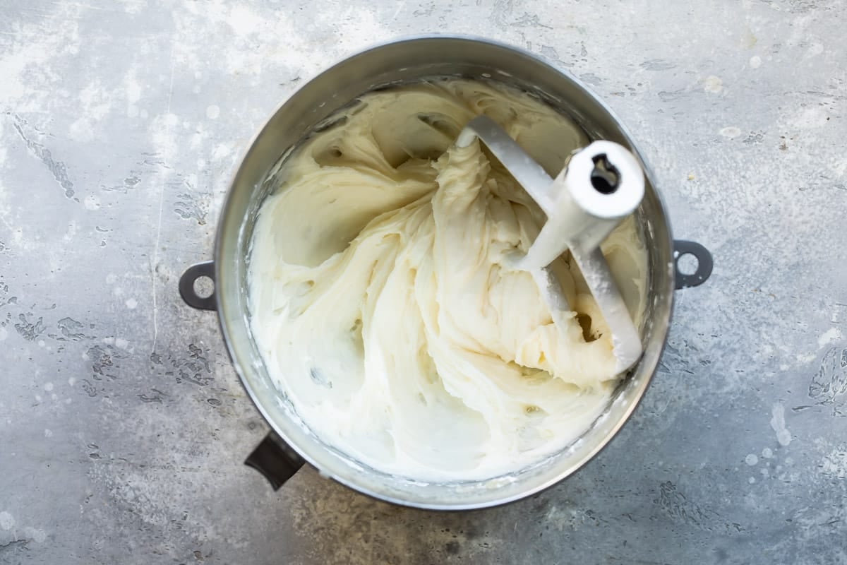 A mixing bowl full of vanilla buttercream frosting.