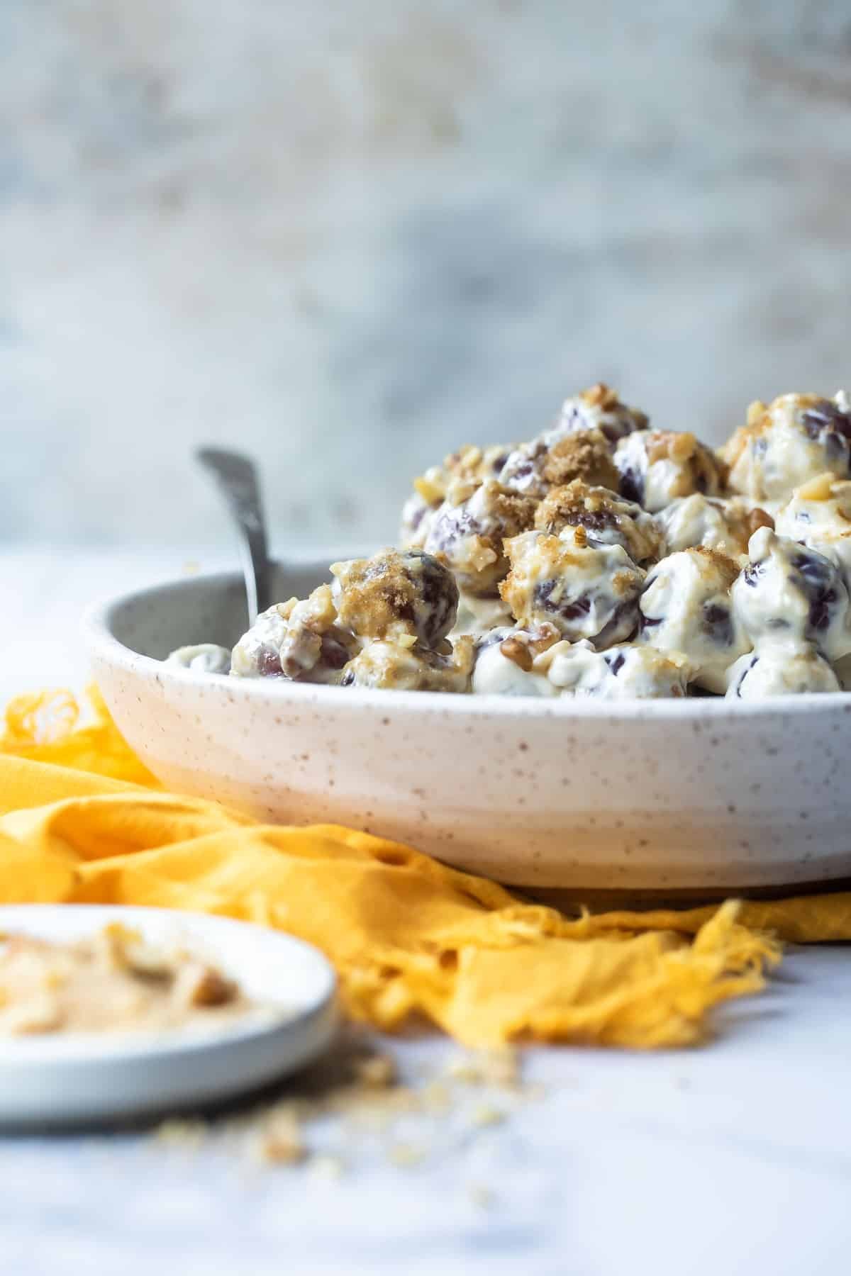 A large serving bowl full of grape salad.