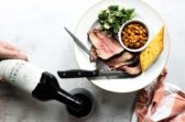 A plate of Santa Maria barbecue with tri-tip, salad, beans, and garlic toast.