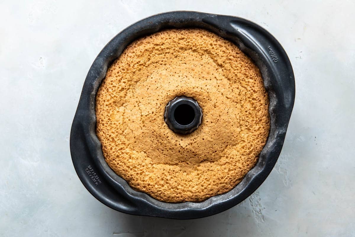 Hot milk cake cooling in a bundt pan.