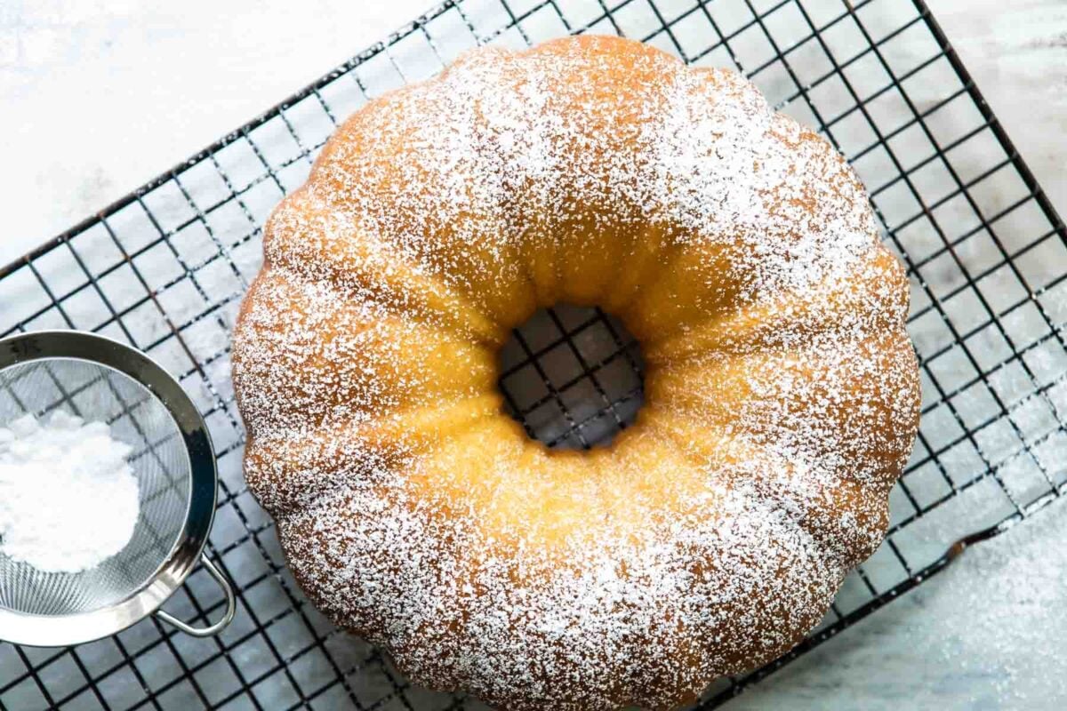 A hot milk cake on a cooling rack.