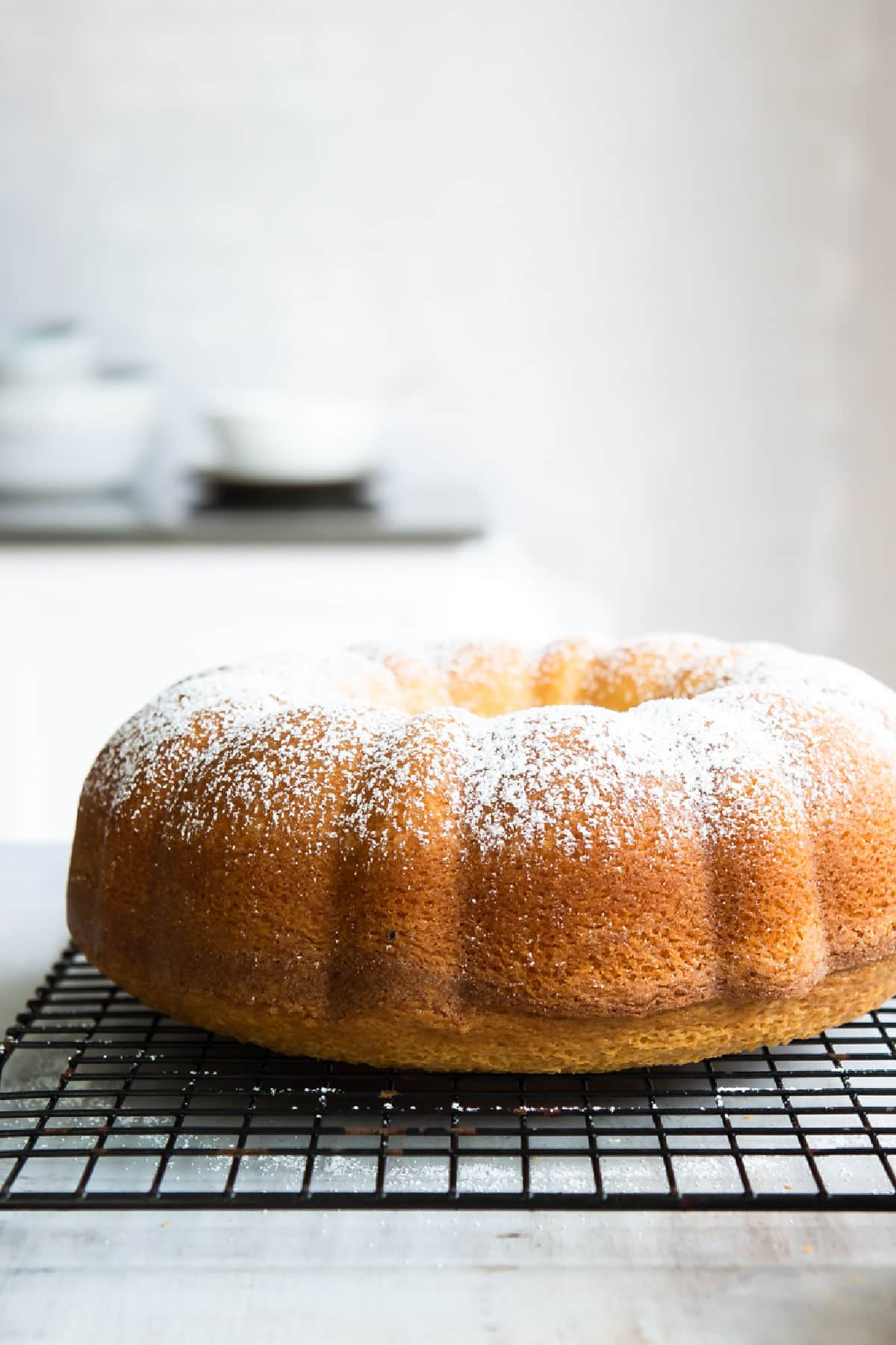A hot milk cake on a cooling rack.