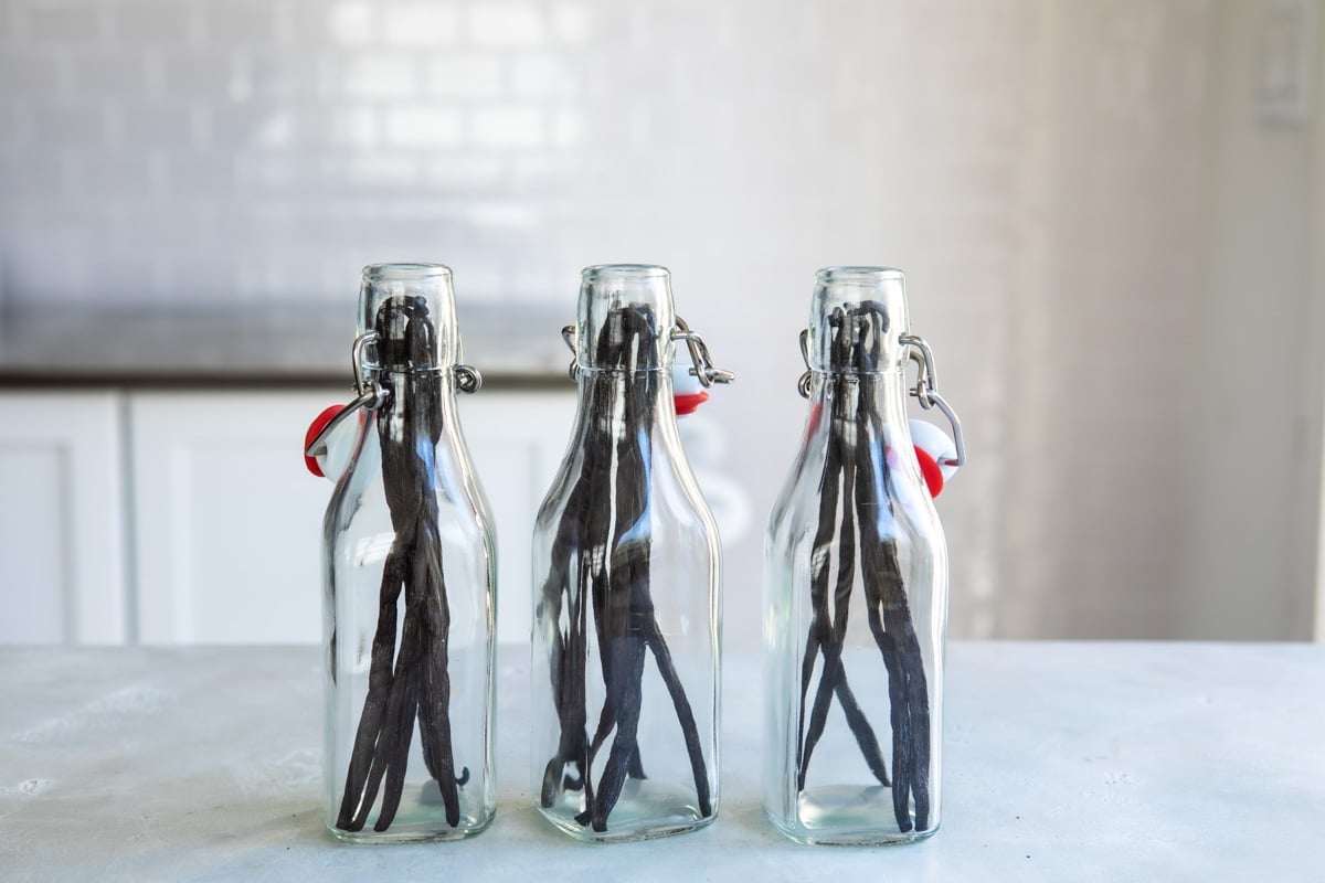 3 bottles with vanilla beans inside.