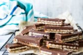 A stack of homemade Twix bars on a cooling rack.