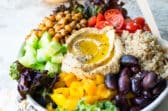 A Mediterranean Buddha bowl on a gray counter.