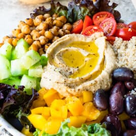 A Mediterranean Buddha bowl on a gray counter.