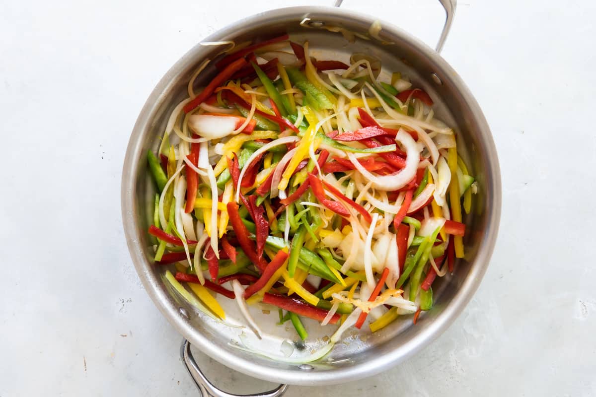 Cooking peppers in a skillet.