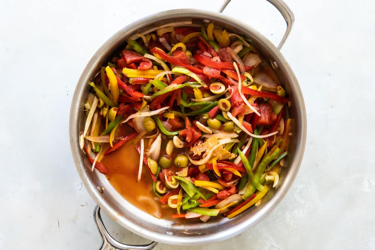 Juicy peppers and olives in a skillet.