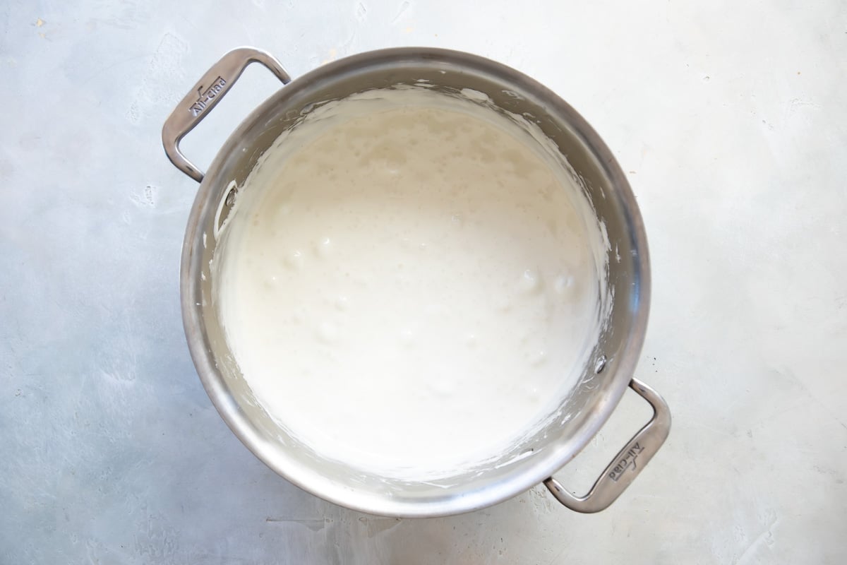 Marshmallow creme for rice krispie treats in a silver pot.