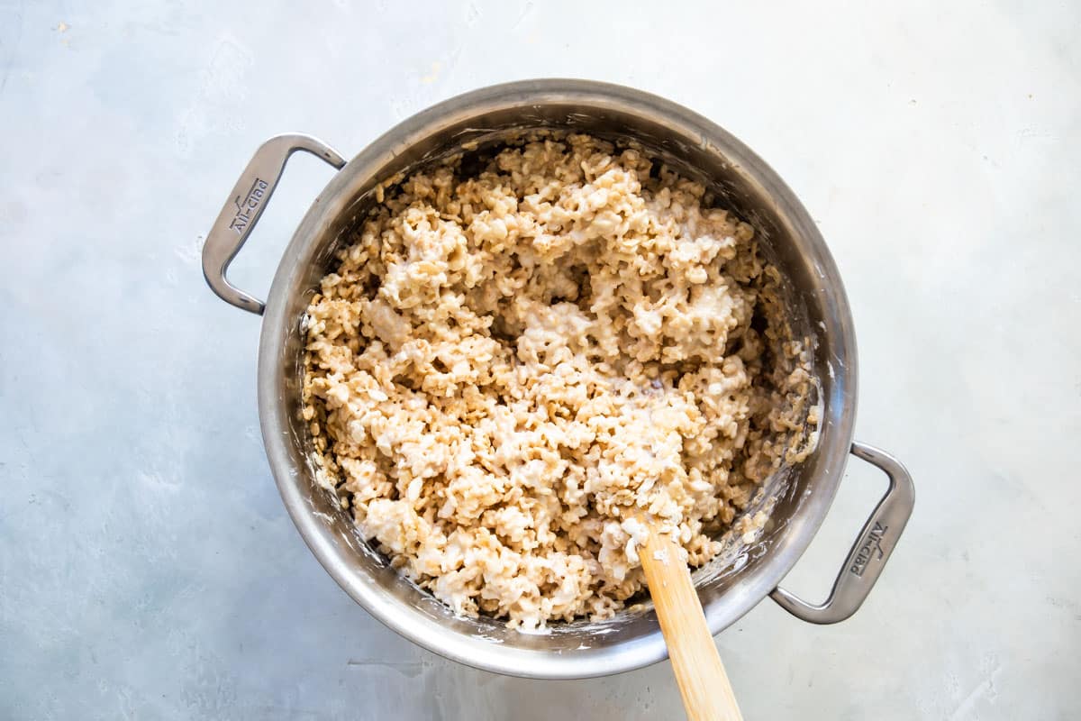 Rice Krispies treats being made in a silver pot.