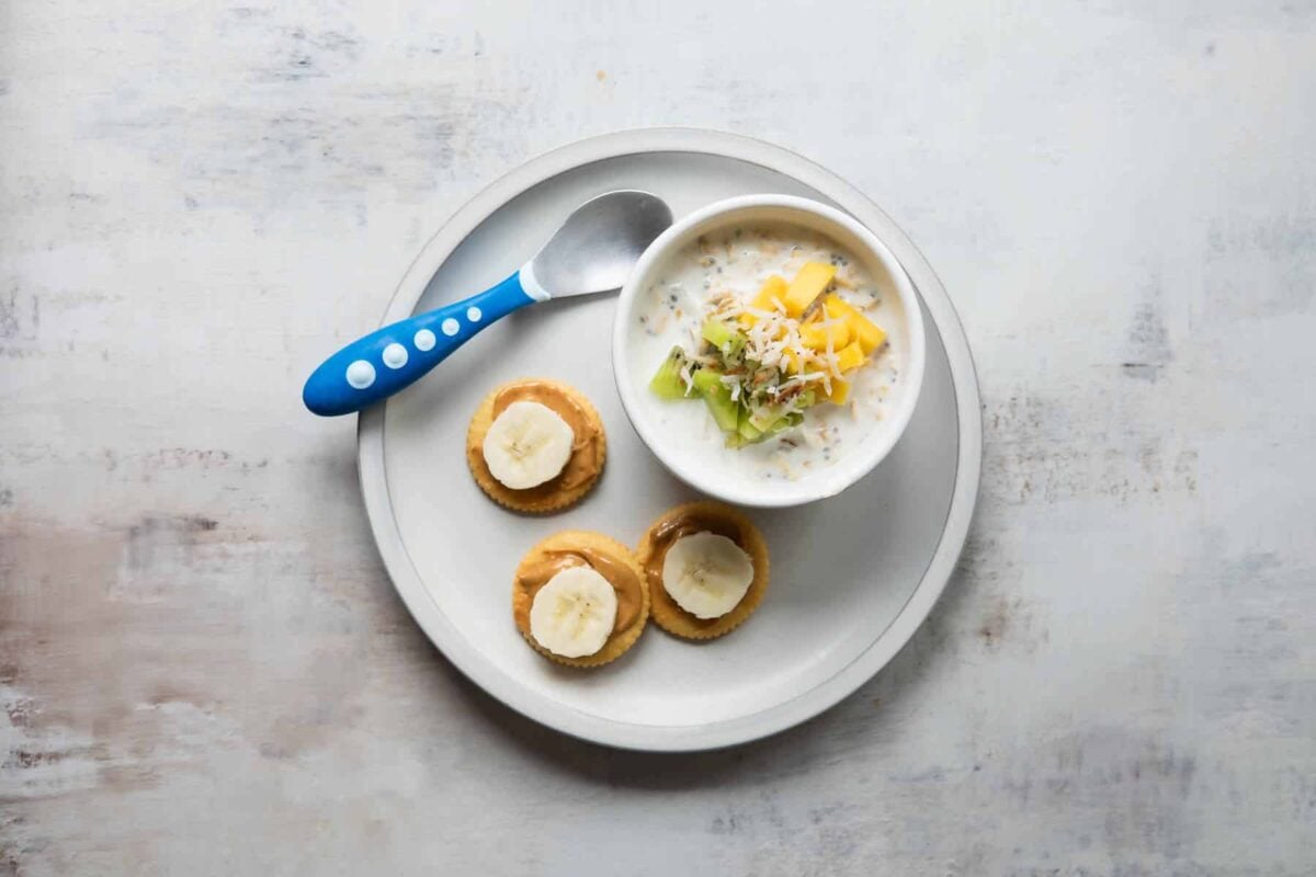 A plate with tropical overnight oats and peanut butter/banana crackers.