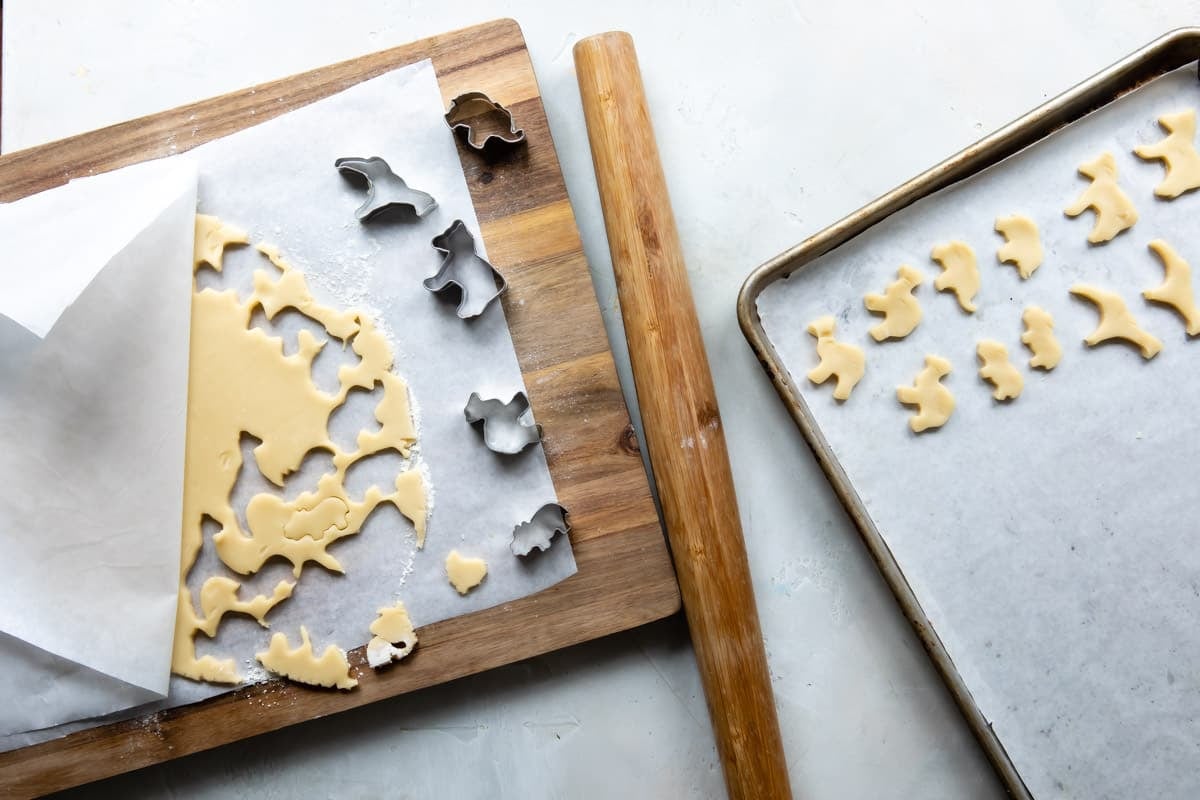Cutting cookie dough into circus animal cookies.