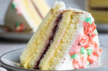 A slice of Danish Layer cake on a small gray plate.