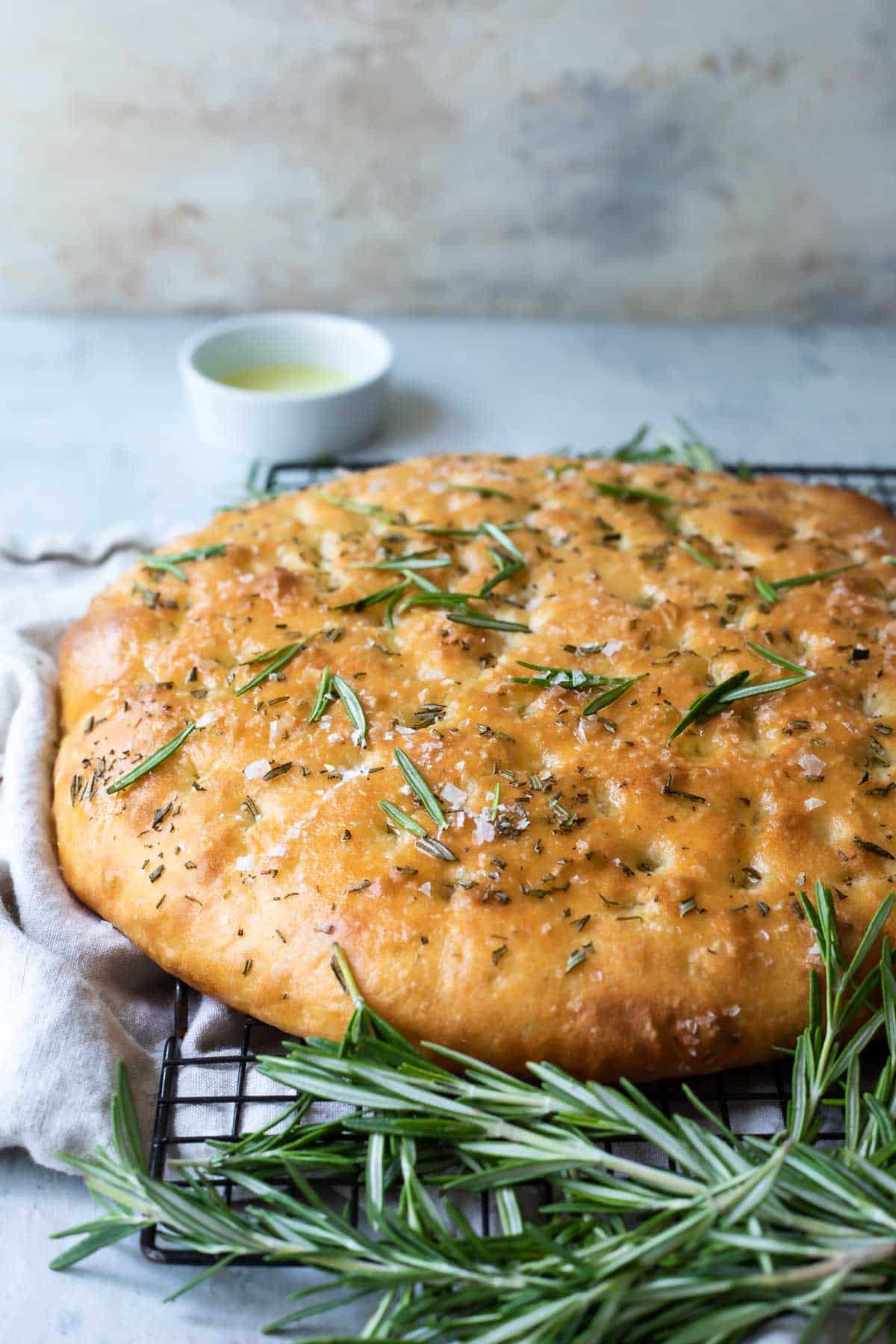 A full, unsliced loaf of focaccia bread.