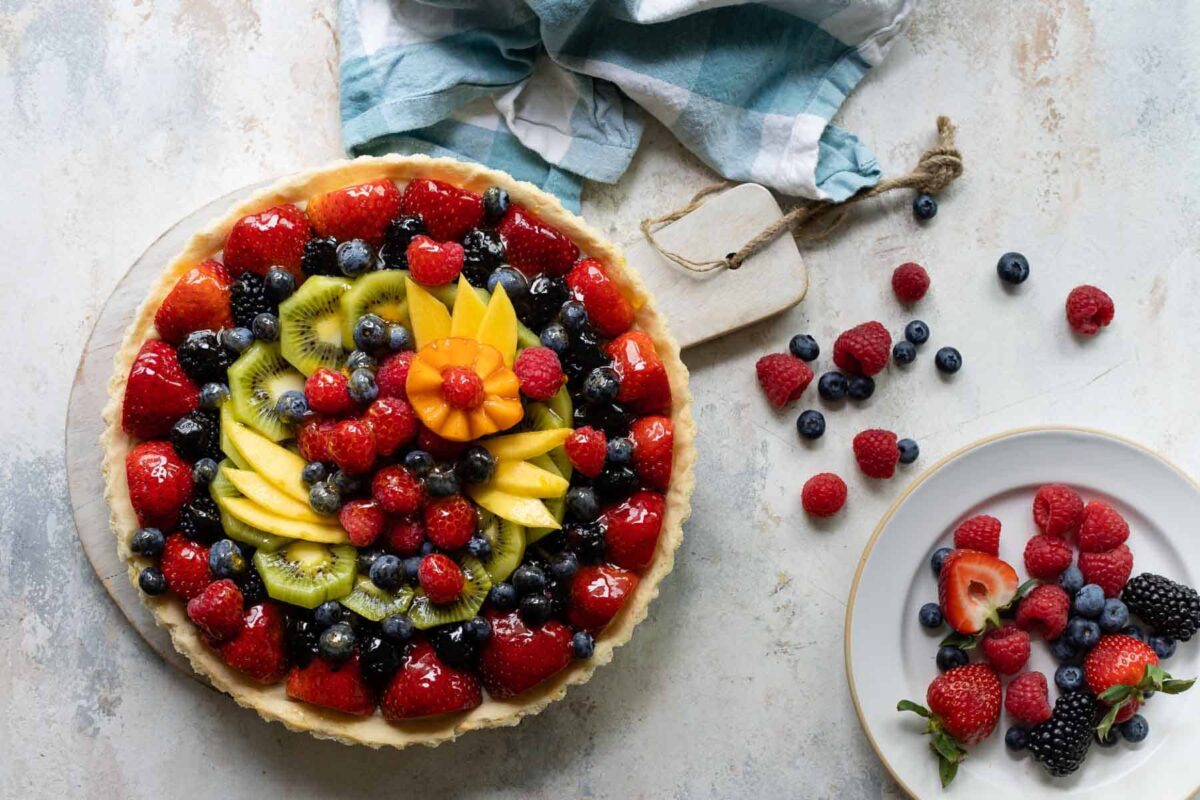 A whole, unsliced fresh fruit tart.