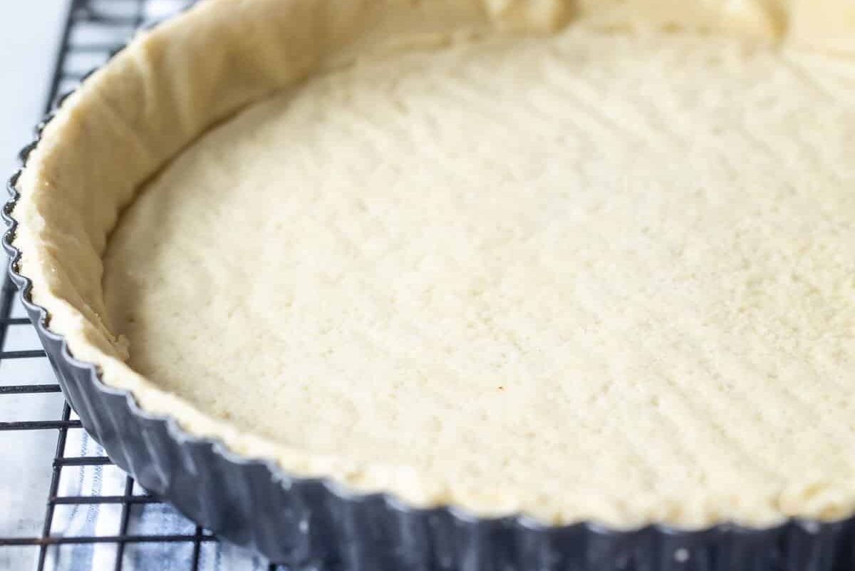 A tart crust on a wire cooling rack.