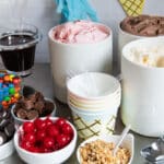 Ice cream and toppings on a countertop for an ice cream sundae bar.