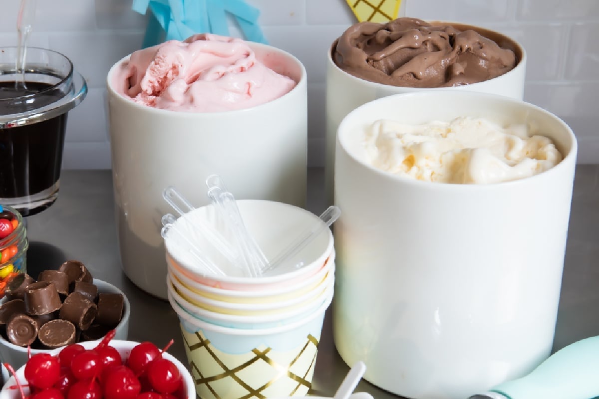 Ice cream and toppings on a countertop for an ice cream sundae bar.