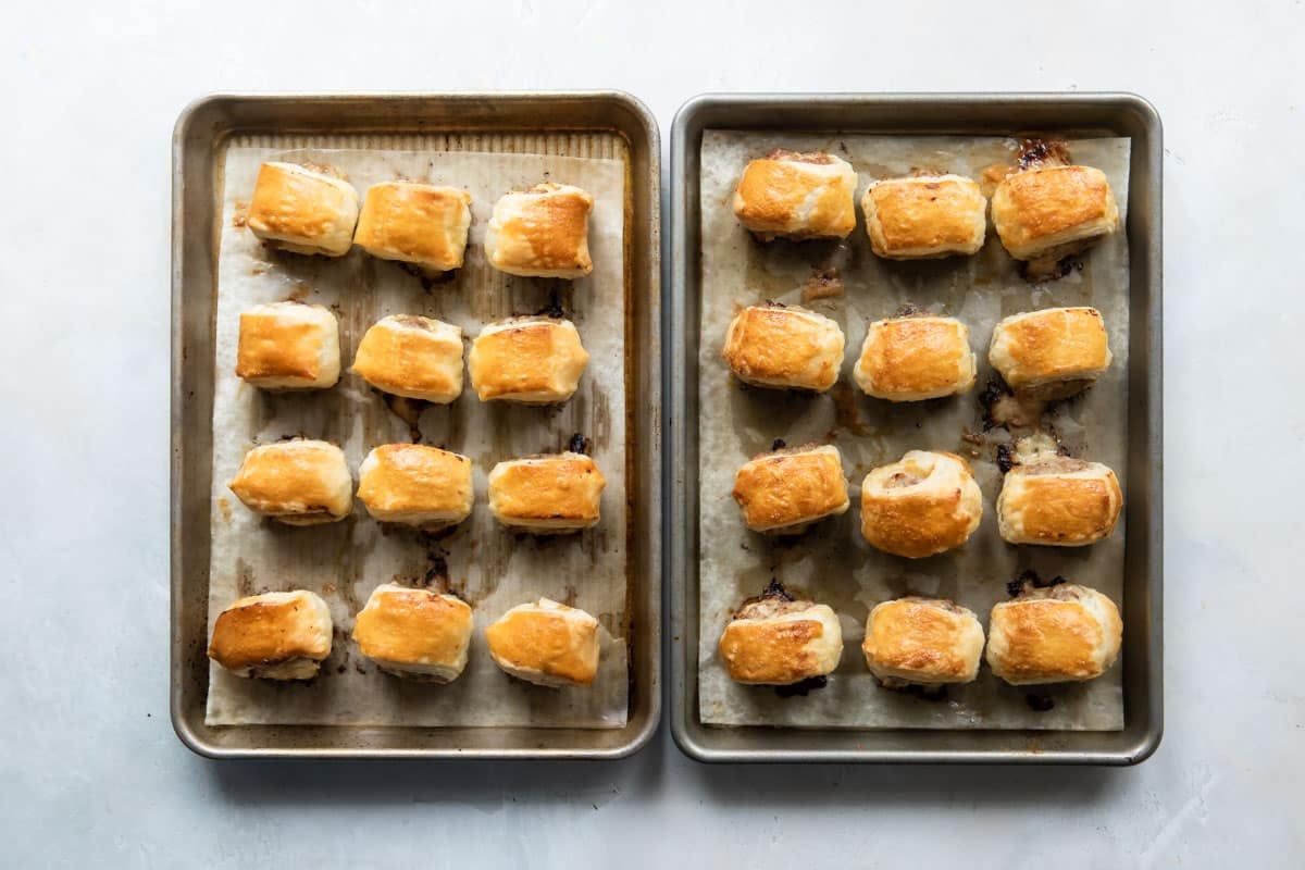 Two baking sheets of sausage rolls.