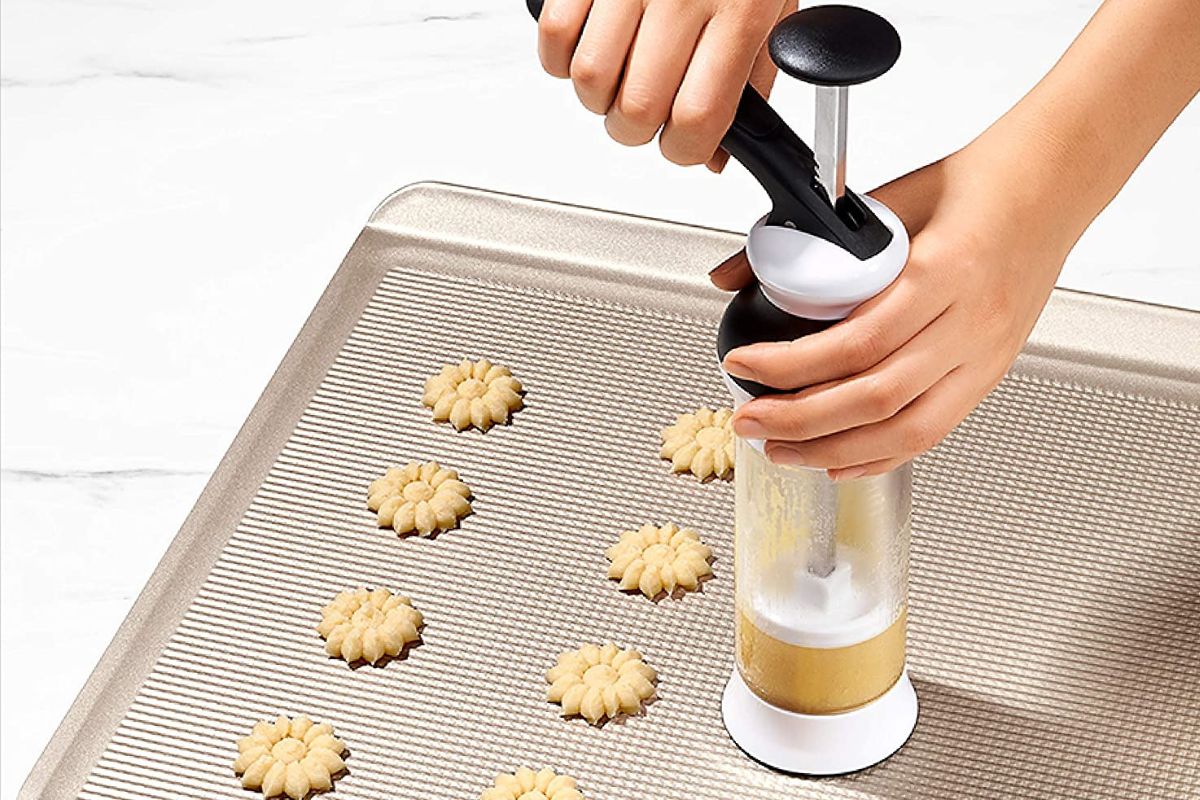 Person holding a cookie press.