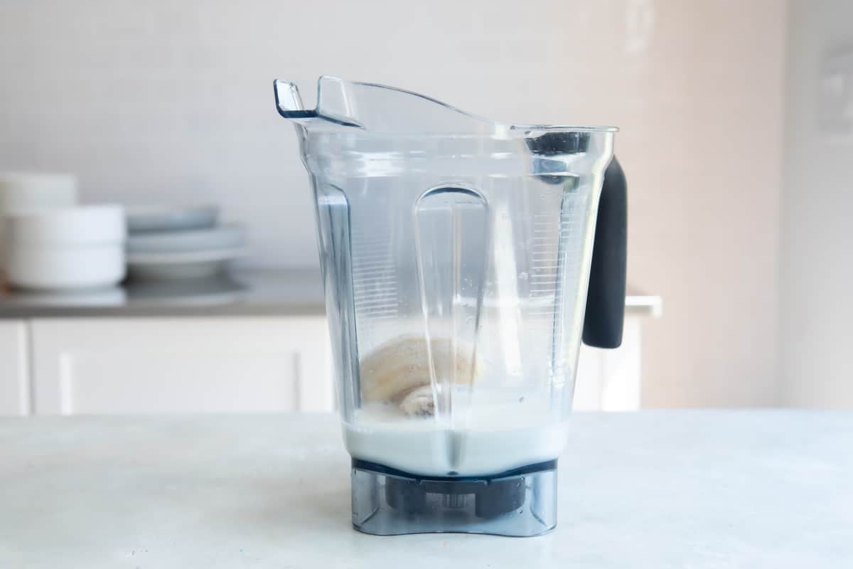 Ingredients for a banana smoothie in a blender.