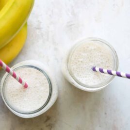 2 jars with Banana Smoothies and straws.