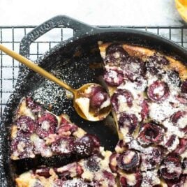A cast iron skillet with Cherry Clafoutis.