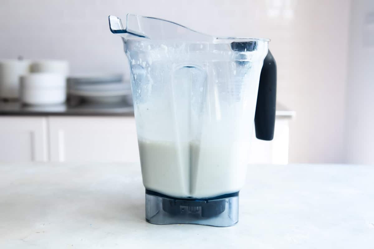 Pineapple smoothie ingredients in a blender.