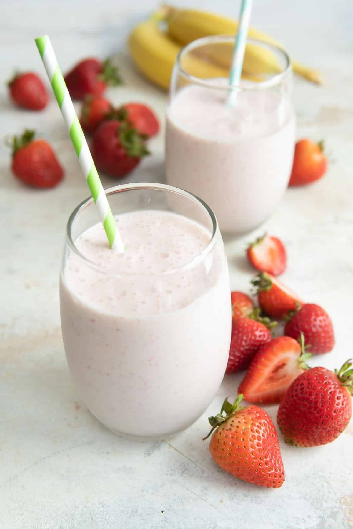 2 glasses full of strawberry-banana smoothie.