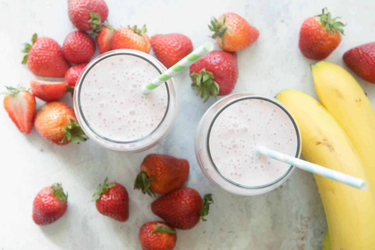 2 glasses full of strawberry-banana smoothie.