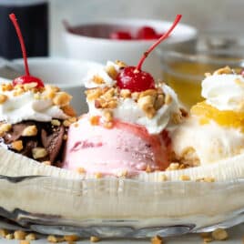 A banana split in a clear dish.