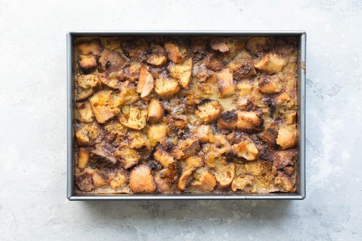 Baked bread pudding in a rectangle baking pan.