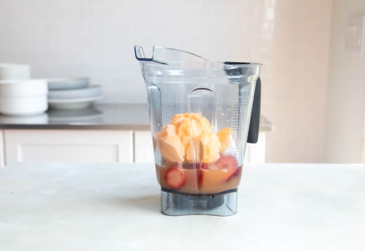 Ingredients for a caribbean passion smoothie in a blender.
