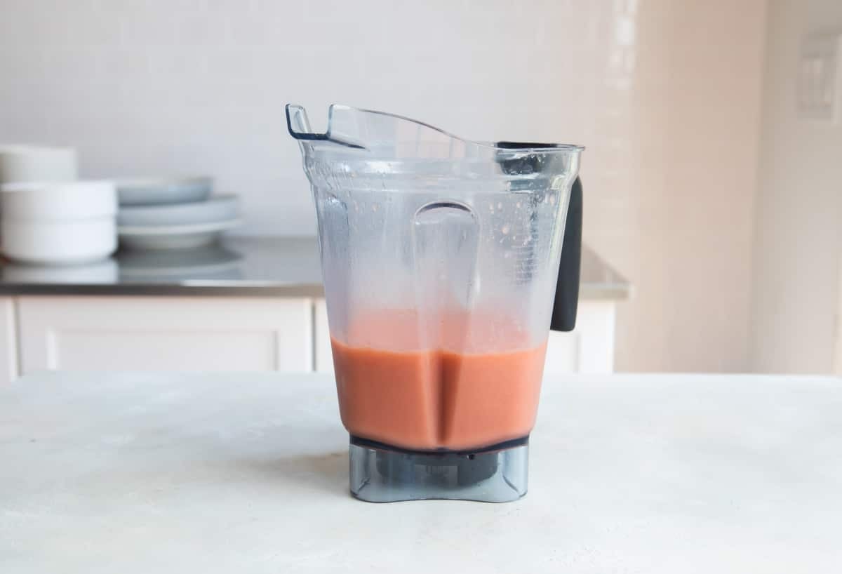 Ingredients for a caribbean passion smoothie in a blender, blended.