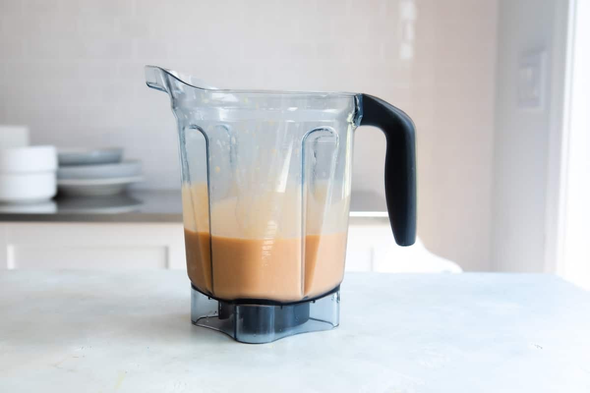 Carrot smoothie ingredients in a blender.