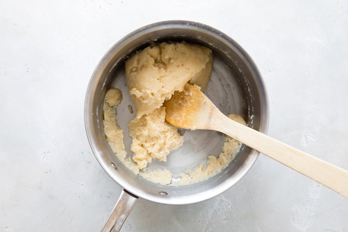 Pate-choux dough for cream puffs in a mixing bowl.