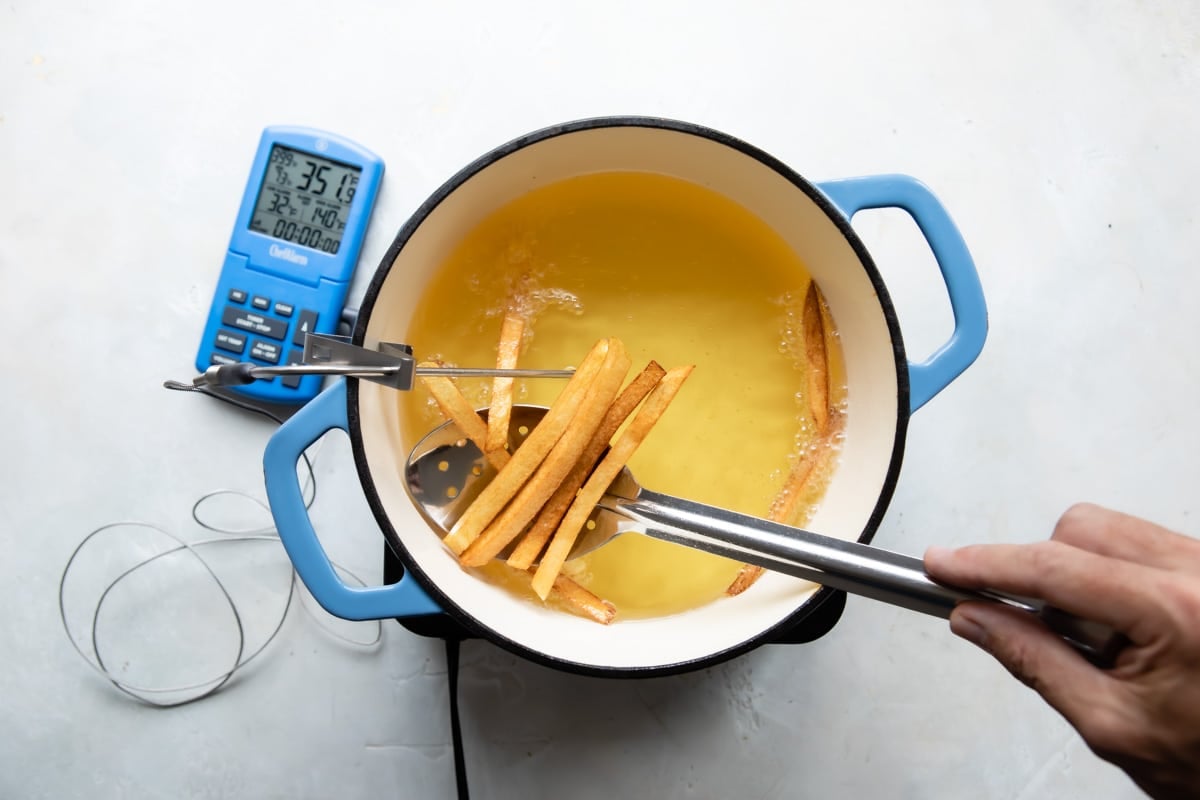 Frying French fries in a Dutch oven full of oil.