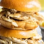 2 hot turkey sandwiches piled on a plate.
