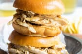 2 hot turkey sandwiches piled on a plate.