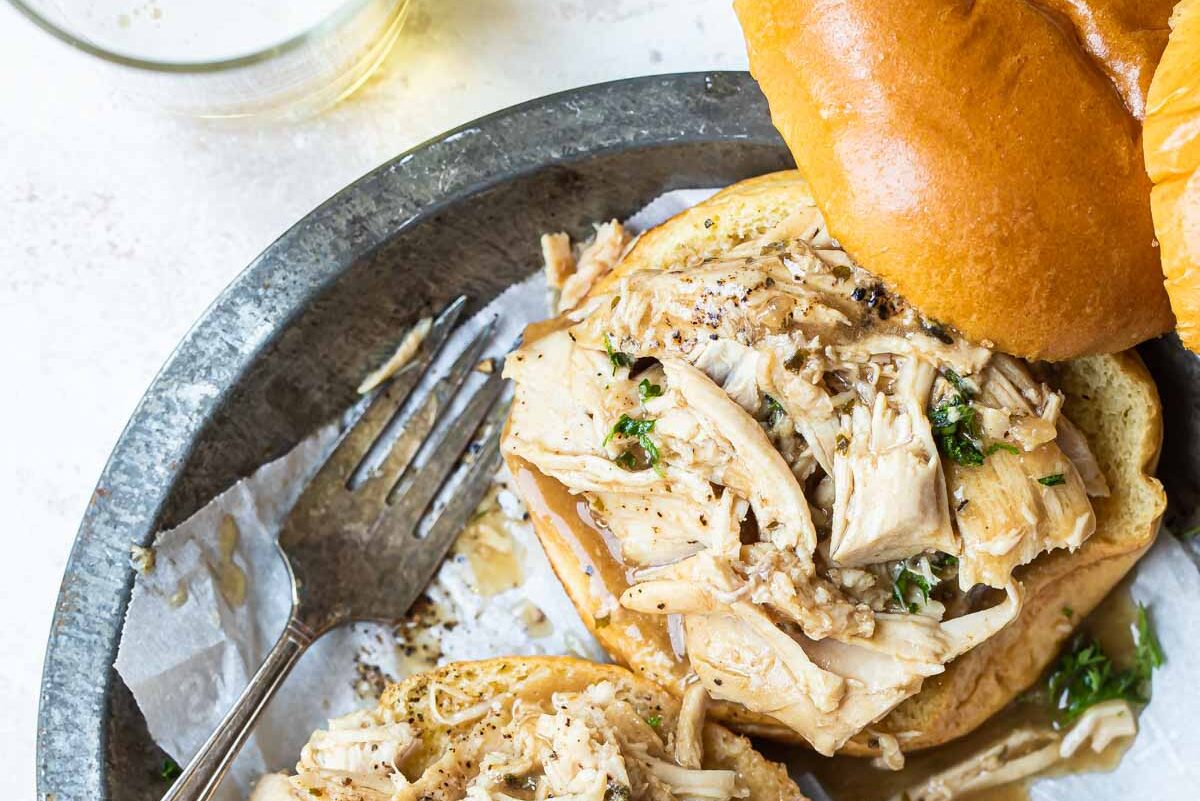2 hot turkey sandwiches piled on a plate.