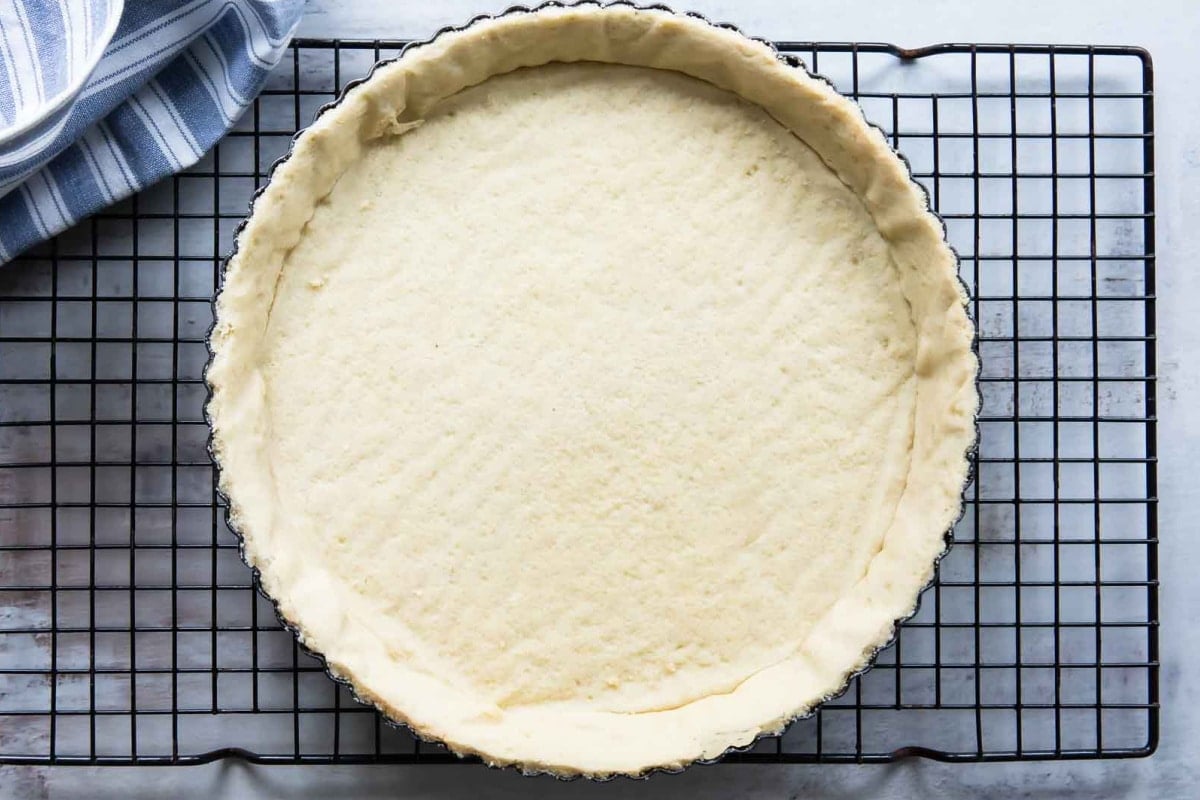 A tart crust on a cooling rack.