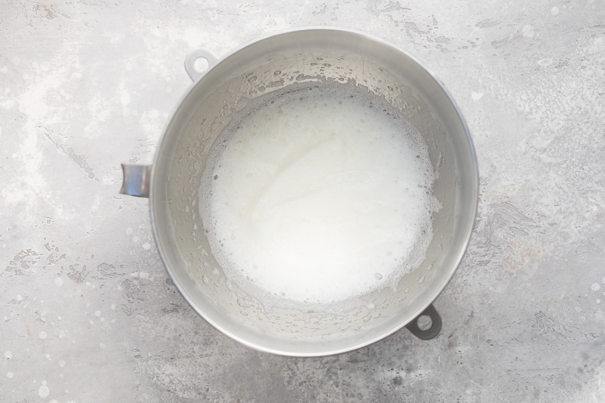 Egg whites whipped in a mixing bowl.