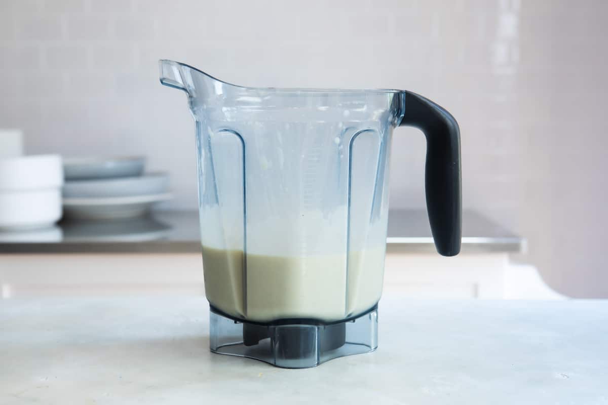 Ingredients for a mango smoothie in a blender.