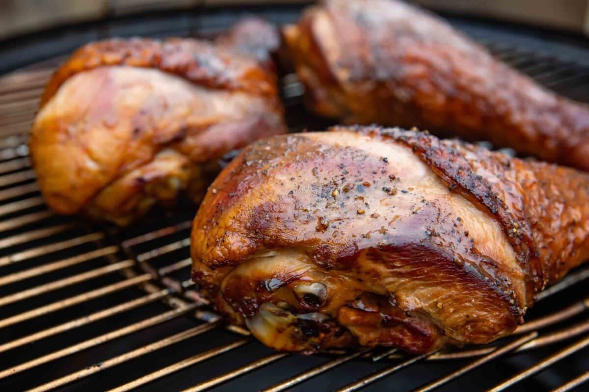 Smoked turkey legs on a smoking grate.