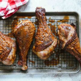 Smoked turkey legs on a baking rack.