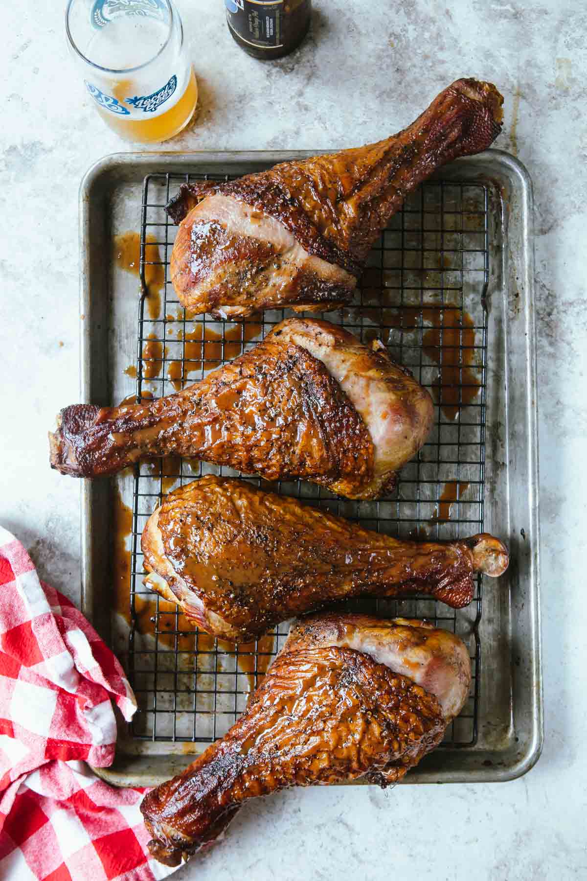 Smoked turkey legs on a baking rack.