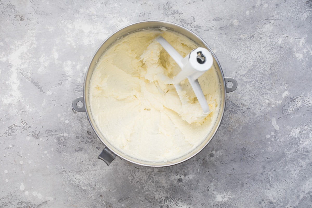Creaming together butter, shortening, and sugar in a mixing bowl for Snickerdoodle cookies.