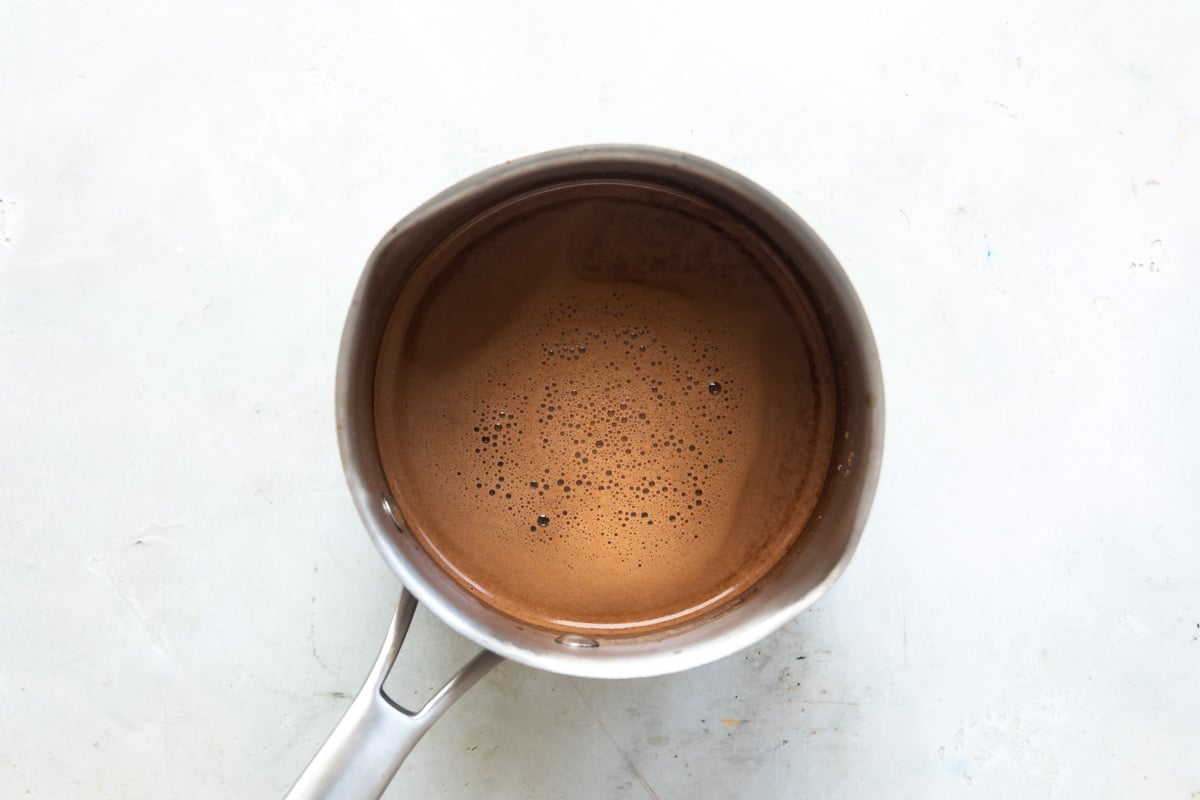 Cooking hot cocoa in boiling water.